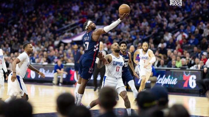 Mar 27, 2024; Philadelphia, Pennsylvania, USA; Philadelphia 76ers guard Buddy Hield (17) drives for a shot past LA Clippers forward P.J. Tucker (17) during the second quarter at Wells Fargo Center. Mandatory Credit: Bill Streicher-USA TODAY Sports