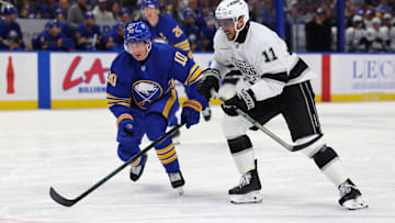 Oct 10, 2024; Buffalo, New York, USA;  Buffalo Sabres defenseman Henri Jokiharju (10) and Los Angeles Kings center Anze Kopitar (11) go after a loose puck during the first period at KeyBank Center. Mandatory Credit: Timothy T. Ludwig-Imagn Images
