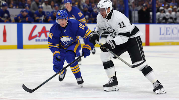 Oct 10, 2024; Buffalo, New York, USA;  Buffalo Sabres defenseman Henri Jokiharju (10) and Los Angeles Kings center Anze Kopitar (11) go after a loose puck during the first period at KeyBank Center. Mandatory Credit: Timothy T. Ludwig-Imagn Images