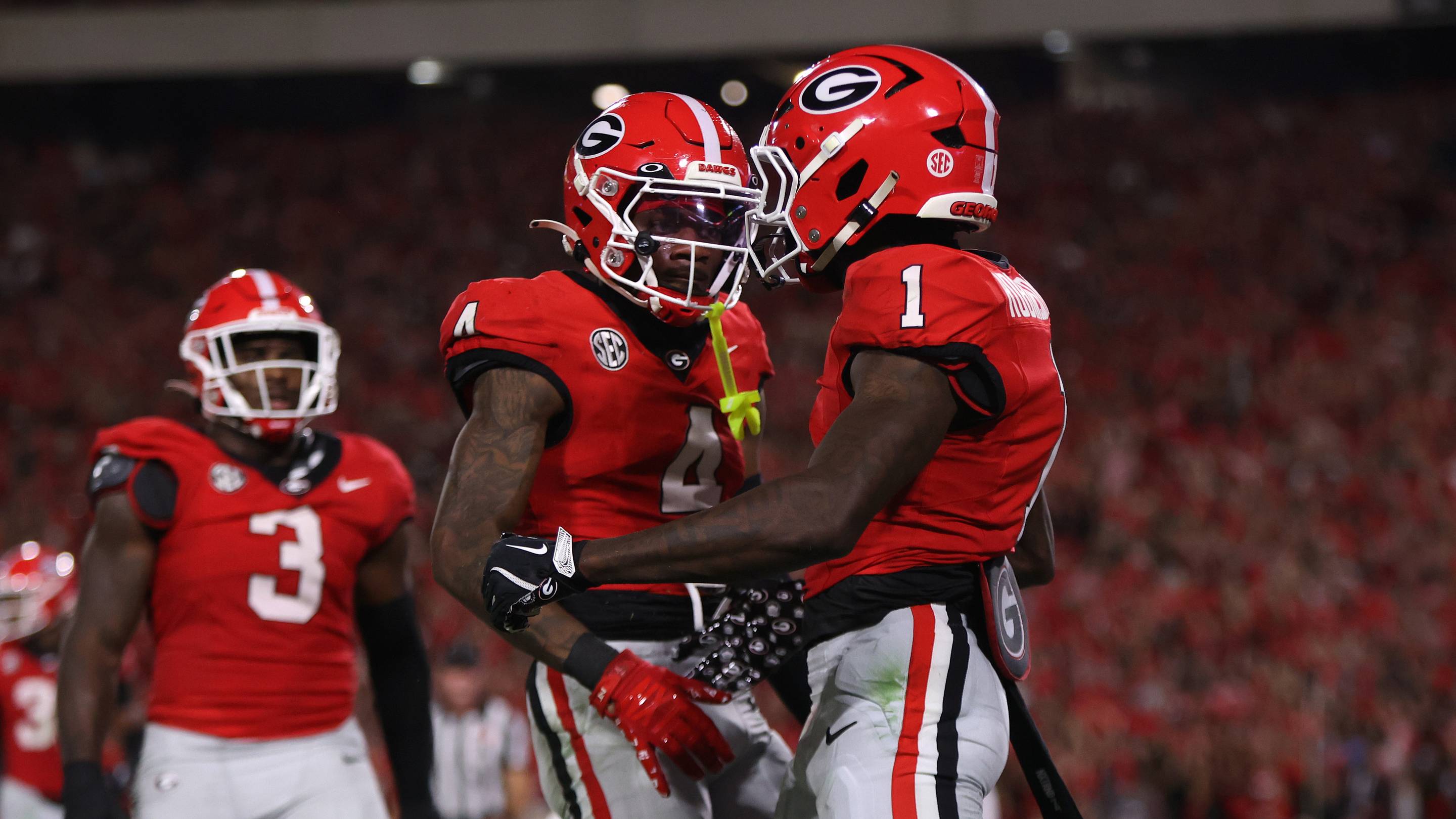 Sep 27, 2025; Athens, Georgia, USA; Georgia Bulldogs defensive back Ellis Robinson IV (1) and defensive back KJ Bolden (4) react in the first half against the Alabama Crimson Tide at Sanford Stadium. Mandatory Credit: Brett Davis-Imagn Images