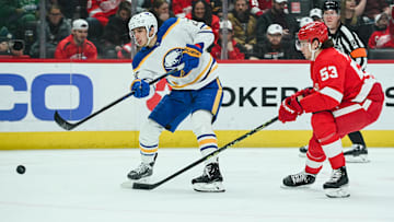 Apr 6, 2023; Detroit, Michigan, USA; Buffalo Sabres center Dylan Cozens (24) shoots as Detroit Red Wings defenseman Moritz Seider (53) defends during the third period at Little Caesars Arena. Mandatory Credit: Tim Fuller-Imagn Images