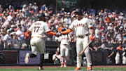 San Francisco, California, USA; San Francisco Giants left fielder Heliot Ramos (17) is congratulated by third baseman Matt Chapman (26) after scoring  a run against the Washington Nationals in the eighth inning at Oracle Park.