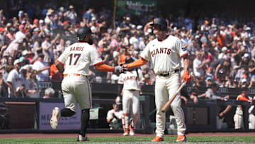San Francisco, California, USA; San Francisco Giants left fielder Heliot Ramos (17) is congratulated by third baseman Matt Chapman (26) after scoring  a run against the Washington Nationals in the eighth inning at Oracle Park.