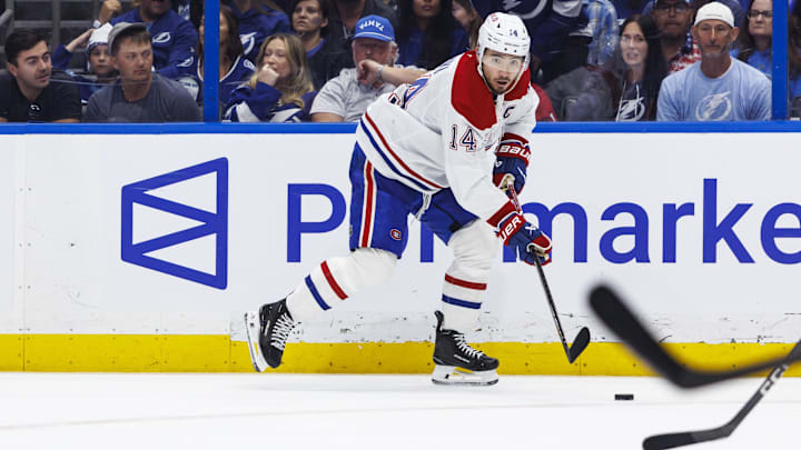 May 3, 2026; Tampa, Florida, USA; Montreal Canadiens forward Nick Suzuki (14) handles the puck against the Tampa Bay Lightning during the second period in game seven of the first round of the 2026 Stanley Cup Playoffs at Benchmark International Arena. Mandatory Credit: Morgan Tencza-Imagn Images