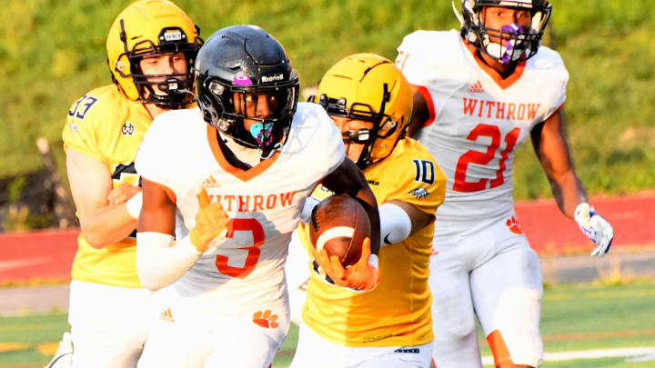 Withrow's Quintin Simmons (3) eyes a long punt return that eventually turned into a race for a Tiger touchdown at Marx Stadium, Aug. 17, 2023.