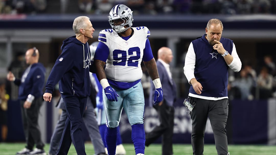 Dec 14, 2025; Arlington, Texas, USA; Dallas Cowboys defensive tackle Quinnen Williams (92) walks off the field with trainers after an injury during the second half against the Minnesota Vikings at AT&T Stadium. Mandatory Credit: Kevin Jairaj-Imagn Images