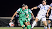 Nov 13, 2016; Queens, NY, USA; New York Cosmos midfielder Andres Flores (11) makes a move around Indy Eleven defender Colin Falvey (32) during the NASL final  at Belson Stadium. Mandatory Credit: Dennis Schneidler-Imagn Images