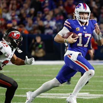 Buffalo Bills quarterback Josh Allen runs toward the sideline against Tampa Bay Buccaneers safety Antoine Winfield Jr.