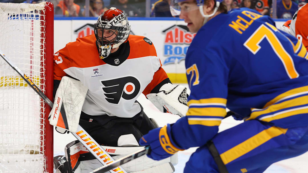 Jan 14, 2026; Buffalo, New York, USA;  Philadelphia Flyers goaltender Samuel Ersson (33) and Buffalo Sabres center Ryan McLeod (71) look for the puck during the second period at KeyBank Center. 