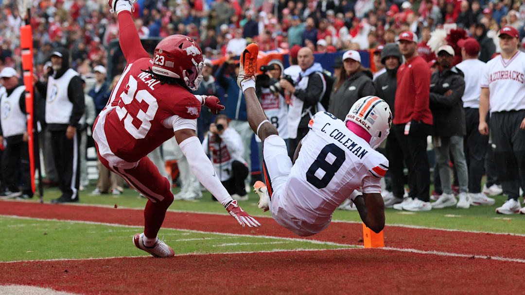Oct 25, 2025; Fayetteville, Arkansas, USA; Auburn Tigers wide receiver Cam Coleman (8) receives a pass for a touchdown as Arkansas Razorbacks defensive back Julian Neal (23) defends during the first quarter at Donald W. Reynolds Razorback Stadium. Mandatory Credit: Nelson Chenault-Imagn Images Oct 25, 2025; Fayetteville, Arkansas, USA; Auburn Tigers wide receiver Cam Coleman (8) receives a pass for a touchdown as Arkansas Razorbacks defensive back Julian Neal (23) defends during the first quarter at Donald W. Reynolds Razorback Stadium. Mandatory Credit: Nelson Chenault-Imagn Images