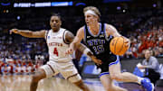 Mar 22, 2025; Denver, CO, USA; Brigham Young Cougars forward Richie Saunders (15) dribbles the ball past Wisconsin Badgers guard Kamari McGee (4) during the second half in the second round of the NCAA Tournament  at Ball Arena. Mandatory Credit: Isaiah J. Downing-Imagn Images