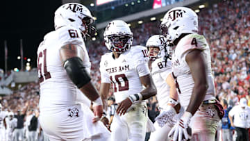 Oct 18, 2025; Fayetteville, Arkansas, USA; Texas A&M Aggies quarterback Marcel Reed (10) celebrates with running back Rueben Owens II (4) after Owne rushed for a touchdown in the fourth quarter against the Arkansas Razorbacks at Donald W. Reynolds Razorback Stadium. Mandatory Credit: Nelson Chenault-Imagn Images
