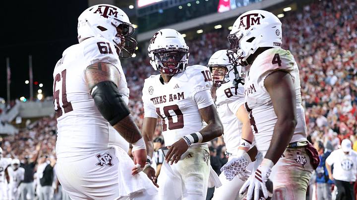 Oct 18, 2025; Fayetteville, Arkansas, USA; Texas A&M Aggies quarterback Marcel Reed (10) celebrates with running back Rueben Owens II (4) after Owner rushed for a touchdown in the fourth quarter against the Arkansas Razorbacks at Donald W. Reynolds Razorback Stadium. Mandatory Credit: Nelson Chenault-Imagn Images