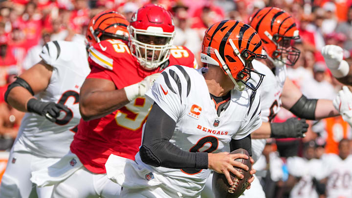 Sep 15, 2024; Kansas City, Missouri, USA; Cincinnati Bengals quarterback Joe Burrow (9) scrambles as Kansas City Chiefs defensive tackle Chris Jones (95) chases during the first half at GEHA Field at Arrowhead Stadium. Mandatory Credit: Denny Medley-Imagn Images