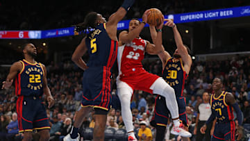 Dec 19, 2024; Memphis, Tennessee, USA; Memphis Grizzlies guard Desmond Bane (22) drives to the basket between Golden State Warriors forward Kevon Looney (5) and guard Stephen Curry (30) during the first quarter at FedExForum. Mandatory Credit: Petre Thomas-Imagn Images