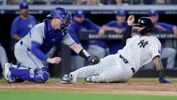 Aug 2, 2024; Bronx, New York, USA; Toronto Blue Jays catcher Brian Serven (15) tags out New York Yankees second baseman Gleyber Torres (25) trying to score on a base hit by Yankees shortstop Anthony Volpe (not pictured) during the second inning at Yankee Stadium. Mandatory Credit: Brad Penner-USA TODAY Sports