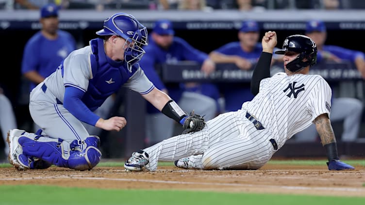 Aug 2, 2024; Bronx, New York, USA; Toronto Blue Jays catcher Brian Serven (15) tags out New York Yankees second baseman Gleyber Torres (25) trying to score on a base hit by Yankees shortstop Anthony Volpe (not pictured) during the second inning at Yankee Stadium. Mandatory Credit: Brad Penner-USA TODAY Sports