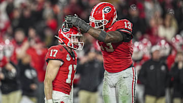 Nov 29, 2024; Athens, Georgia, USA; Georgia Bulldogs defensive back Dan Jackson (17) reacts with defensive lineman Mykel Williams (13) after sacking Georgia Tech Yellow Jackets quarterback Haynes King (10) (not pictured) during overtime at Sanford Stadium. Mandatory Credit: Dale Zanine-Imagn Images