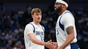 Oct 11, 2025; Dallas, Texas, USA; Dallas Mavericks forward Cooper Flagg (32) low fives forward/center Anthony Davis (3) in the first half of game against the Charlotte Hornets at American Airlines Center. Mandatory Credit: Raymond Carlin III-Imagn Images