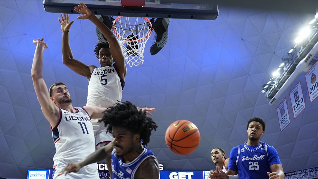 Feb 28, 2026; Storrs, Connecticut, USA; UConn Huskies forward Tarris Reed Jr. (5) and UConn Huskies forward Alex Karaban (11) defend against Seton Hall Pirates guard Tajuan Simpkins (2) in the first half at Harry A. Gampel Pavilion. Mandatory Credit: David Butler II-Imagn Images