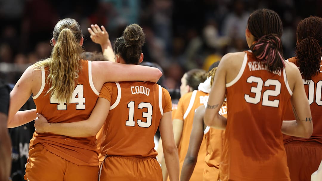 Apr 4, 2025; Tampa, FL, USA;  Texas Longhorns forward Taylor Jones (44) and Texas Longhorns guard Jordana Codio (13) walk off the court after losing to South Carolina Gamecocks during the semifinal of the women's 2025 NCAA tournament at Amalie Arena. Mandatory Credit: Nathan Ray Seebeck-Imagn Images