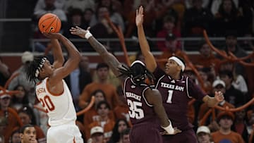 Jan 25, 2025; Austin, Texas, USA; Texas Longhorns guard Tre Johnson (20) shoots over Texas A&M Aggies guards Manny Obaseki (35) and Zhuric Phelps (1) during the second half at Moody Center. Mandatory Credit: Scott Wachter-Imagn Images