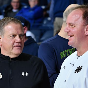Feb 7, 2017; South Bend, IN, USA; Notre Dame Fighting Irish head football coach Brian Kelly and his defensive coordinator Mike Elko watch warmups before the game between the Notre Dame Fighting Irish and the Wake Forest Demon Deacons at the Purcell Pavilion. Mandatory Credit: Matt Cashore-Imagn Images