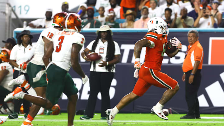 Sep 7, 2024; Miami Gardens, Florida, USA; Miami Hurricanes running back Damien Martinez (6) runs with the football for a touchdown against the Florida A&M Rattlers during the third quarter at Hard Rock Stadium. Mandatory Credit: Sam Navarro-Imagn Images