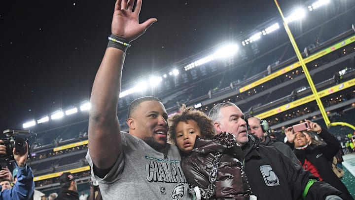 Philadelphia Eagles running back Saquon Barkley and son after the team's NFC Championship win on Jan 26, 2025.