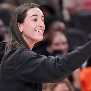 Indiana Fever's Caitlin Clark (22) gives a thumbs up to Los Angeles Sparks's Kelsey Plum (10) after she travels with the ball Saturday, July 19, 2025, during the WNBA All-Star Game at Gainbridge Fieldhouse in Indianapolis.