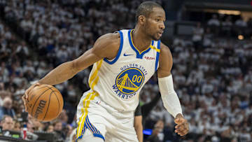 Golden State Warriors forward Jonathan Kuminga dribbles the ball against the Minnesota Timberwolves.