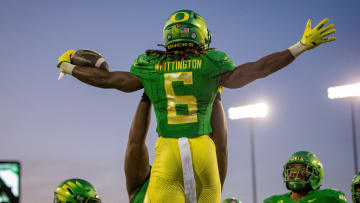 Oregon running back Noah Whittington is hoisted into the air after a touchdown.