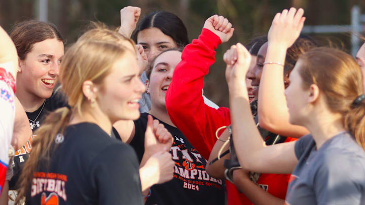 Taunton senior pitcher and captain Cate Larson (center) leads a huddle at the end of a practice on March 28, 2025.