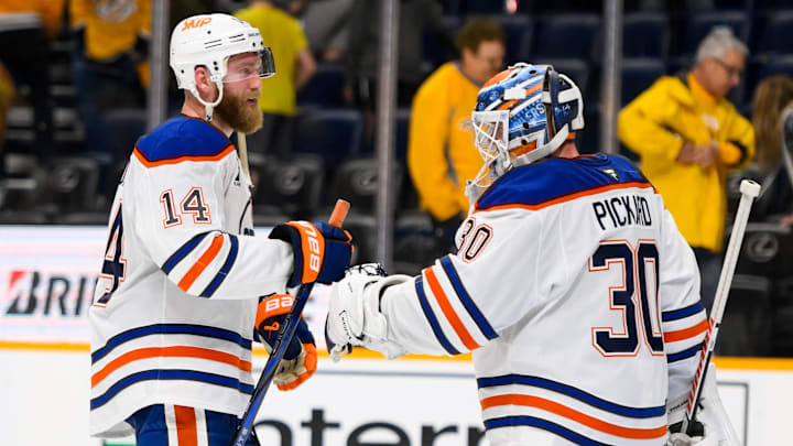 Edmonton Oilers defenseman Mattias Ekholm celebrates the win with goaltender Calvin Pickard.