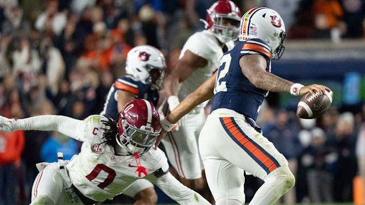 Nov 29, 2025; Auburn, Alabama, USA; Alabama linebacker Deontae Lawson (0) pressures Auburn quarterback Ashton Daniels (12) on the final play of the game at Jordan-Hare Stadium. Alabama defeated Auburn 27-20. Mandatory Credit: Gary Cosby Jr.-Tuscaloosa News