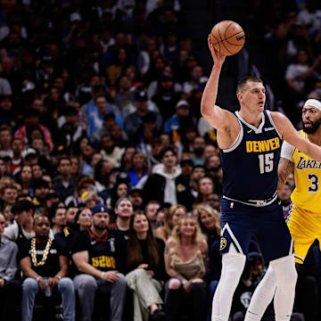 Apr 29, 2024; Denver, Colorado, USA; Denver Nuggets center Nikola Jokic (15) controls the ball as Los Angeles Lakers forward Anthony Davis (3) guards in the first quarter during game five of the first round for the 2024 NBA playoffs at Ball Arena. Mandatory Credit: Isaiah J. Downing-Imagn Images