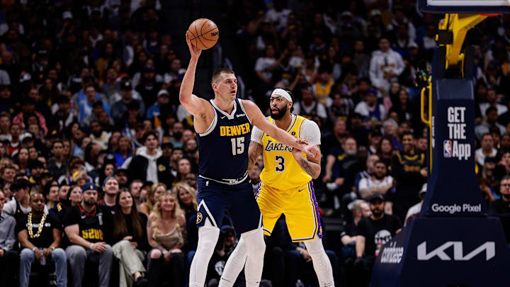 Apr 29, 2024; Denver, Colorado, USA; Denver Nuggets center Nikola Jokic (15) controls the ball as Los Angeles Lakers forward Anthony Davis (3) guards in the first quarter during game five of the first round for the 2024 NBA playoffs at Ball Arena. Mandatory Credit: Isaiah J. Downing-Imagn Images