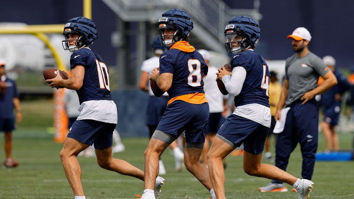 Jul 26, 2024; Englewood, CO, USA; Denver Broncos quarterback Bo Nix (10) and quarterback Jarrett Stidham (8) and quarterback Zach Wilson (4) during training camp at Broncos Park Powered by CommonSpirit.