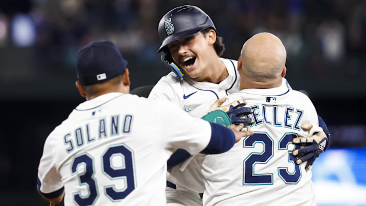 May 31, 2025; Seattle, Washington, USA; Seattle Mariners second baseman Cole Young (2, middle) celebrates with first baseman Rowdy Tellez (23) and infielder Donovan Solano (39) following a walk-off RBI-fielders choice against the Minnesota Twins during the eleventh inning at T-Mobile Park. Mandatory Credit: Joe Nicholson-Imagn Images