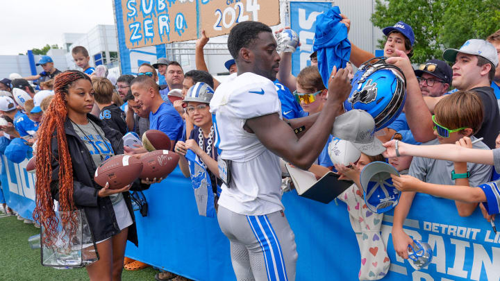 Terrion Arnold signs autographs after Detroit Lions training camp practice