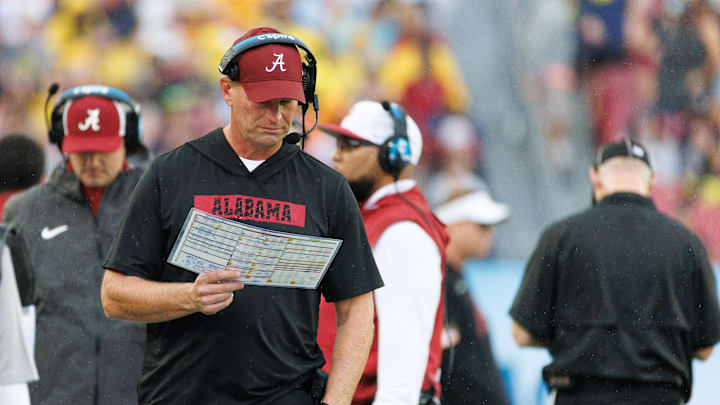 Dec 31, 2024; Tampa, FL, USA; Alabama Crimson Tide head coach Kalen DeBoer reads the playcard against the Michigan Wolverines during the first half at Raymond James Stadium. Mandatory Credit: Matt Pendleton-Imagn Images