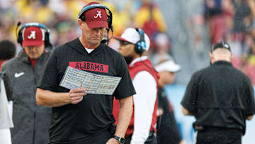 Dec 31, 2024; Tampa, FL, USA; Alabama Crimson Tide head coach Kalen DeBoer reads the playcard against the Michigan Wolverines during the first half at Raymond James Stadium. Mandatory Credit: Matt Pendleton-Imagn Images