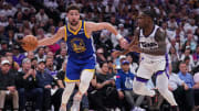 Apr 16, 2024; Sacramento, California, USA; Golden State Warriors guard Klay Thompson (11) drives past Sacramento Kings guard Davion Mitchell (15) in the second quarter during a play-in game of the 2024 NBA playoffs at the Golden 1 Center. Mandatory Credit: Cary Edmondson-USA TODAY Sports