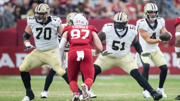 Aug 10, 2024; Glendale, Arizona, USA; New Orleans Saints  offensive tackle Trevor Penning (70) and center Cesar Ruiz (51) against the Arizona Cardinals during a preseason NFL game at State Farm Stadium. Mandatory Credit: Mark J. Rebilas-USA TODAY Sports