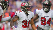 Sep 10, 2023; Minneapolis, Minnesota, USA; Tampa Bay Buccaneers safety Antoine Winfield Jr. (31) celebrates his fumble recovery with defensive tackle Calijah Kancey (94) against the Minnesota Vikings in the first quarter at U.S. Bank Stadium. Mandatory Credit: Brad Rempel-USA TODAY Sports