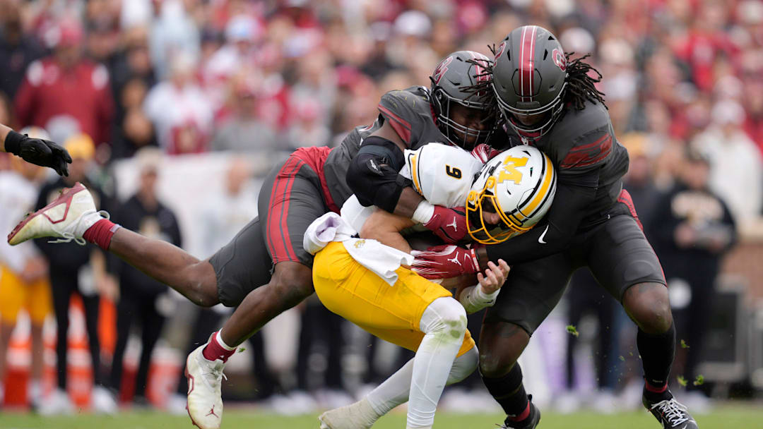 Oklahoma Sooners defensive lineman Adepoju Adebawore (34) and Oklahoma Sooners linebacker Kendal Daniels (5) bring down Missouri Tigers quarterback Beau Pribula (9) Oklahoma Sooners defensive lineman Adepoju Adebawore (34) and Oklahoma Sooners linebacker Kendal Daniels (5) bring down Missouri Tigers quarterback Beau Pribula (9)