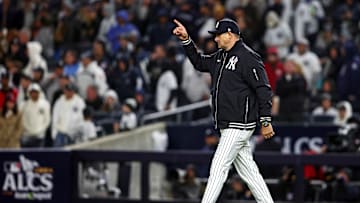 New York Yankees manger Aaron Boone signals to the bull pen for a pitching change eighth inning against the Cleveland Guardians in game one of the ALCS for the 2024 MLB Playoffs at Yankee Stadium.