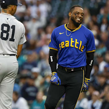 Seattle Mariners designated hitter Victor Robles (right) reacts after getting hit by a pitch during a game against the New York Yankees on Tuesday at T-Mobile Park.