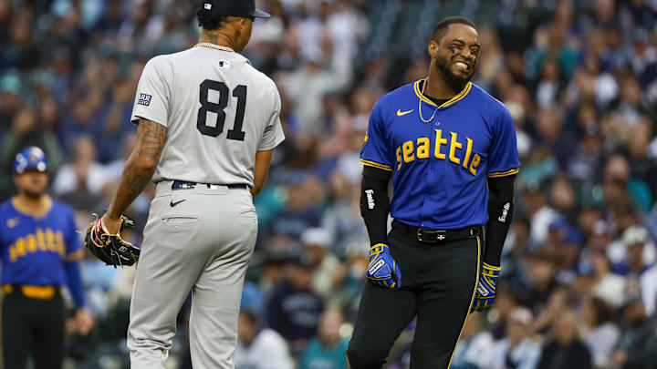 Seattle Mariners designated hitter Victor Robles (right) reacts after getting hit by a pitch during a game against the New York Yankees on Tuesday at T-Mobile Park.