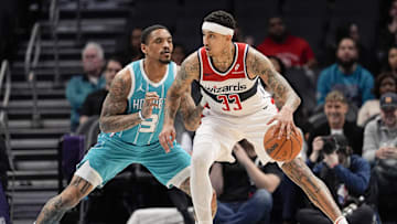 Feb 3, 2025; Charlotte, North Carolina, USA; Washington Wizards forward Kyle Kuzma (33) handles the ball against Charlotte Hornets guard DaQuan Jeffries (3) during the first half at Spectrum Center. Mandatory Credit: Jim Dedmon-Imagn Images